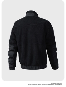 Rear view of black teddy fleece jacket with contrasting windproof fabric panels