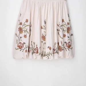 Short cream embroidered dress with colorful floral patterns and a puff hemline