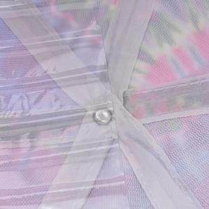 Macro shot of colorful tie-dye mesh fabric and internal reinforcement tape on baseball cap