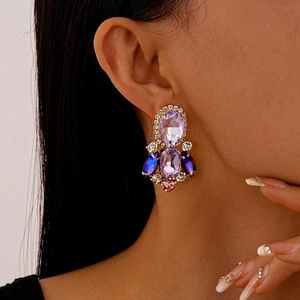 Detail of luxury oval purple gemstone drop earrings with colorful zircon fringe