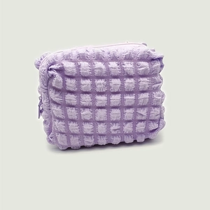 Minimalist light purple bubble textured cosmetic bag with smooth zipper closure for travel