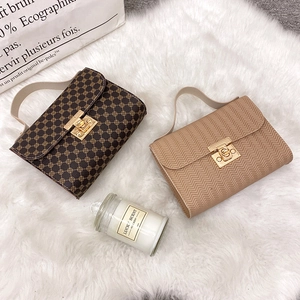 Fashionable crossbody handbags with golden twist lock and chain strap on white faux fur