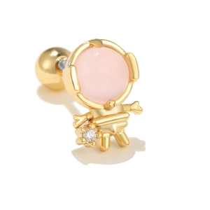 Macro shot of gold astronaut cartilage stud with pink gem helmet and screw ball back