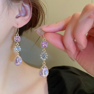Elegant gold drop earrings with purple crystals and sparkling butterfly floral accents