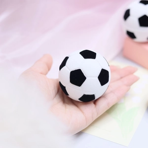 Miniature football-shaped velvet jewelry box for rings and earrings shown in hand