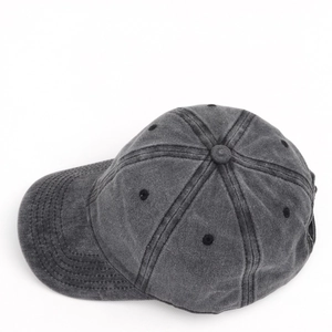 Close-up of a grey washed canvas baseball cap featuring six-panel structure and vent holes
