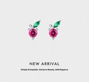 Macro detail of S925 silver cherry earrings with pink and green zircon stones
