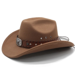 Vintage brown felt cowboy hat with leather band and metal bull head buckle decoration
