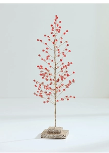 Detail of red bead berries and gold-coated branches on an acrylic holiday display tree