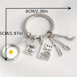 Detailed view of kitchen theme keychain with frying pan, mixer and cookbook pendants