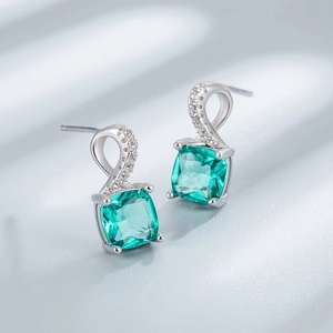 Square emerald green gemstone studs with twisted silver metal and sparkling diamonds