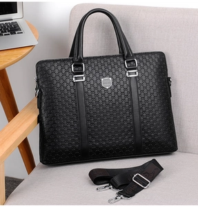 Macro detail of black leather texture and kangaroo logo on men's business briefcase