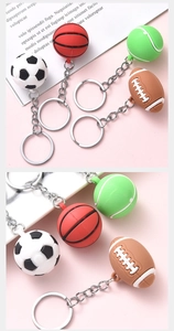Detailed close-up of sport ball keychains including soccer, basketball, tennis, and rugby