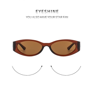 Detail of oval sunglasses featuring transparent tea brown frames and matching lenses