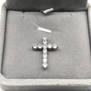 Close-up of a shimmering S925 sterling silver cross pendant with clear cubic zirconia