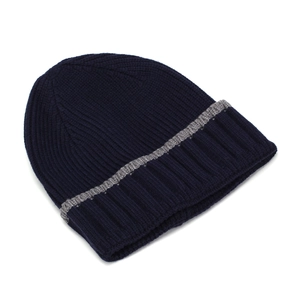 Detail of navy knit beanie with gray stripe and thick ribbed texture for winter warmth