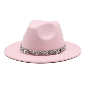 Detail of pink wool felt fedora featuring a silver sequin band and golden M logo