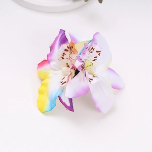 Close-up of artificial orchid hair clip with colorful petals and pearl accents