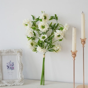 Close-up of artificial white chrysanthemums with green centers for home decor settings