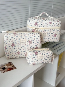 Detailed set of three quilted floral bear makeup bags in various storage sizes