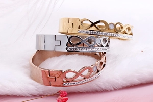 Detailed view of infinity bracelets in gold, silver, and rose gold with double row crystals