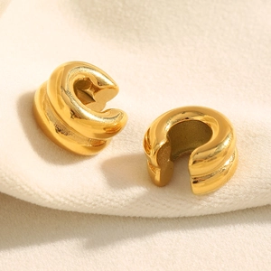 Minimalist double-layer 18K gold plated stainless steel ear cuffs on beige fabric background