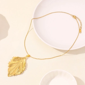 Detailed view of golden leaf pendant with realistic vein texture and 18KGP lobster clasp