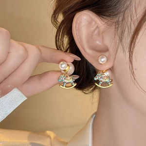 Elegant gold rocking horse pearl earrings with blue enamel finish for women