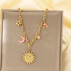 Close-up of 18K gold plated chain with celestial sun, pink moon, and star pendants