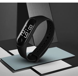 Detail of waterproof LED digital sports watch with black silicone strap on geometric backdrop