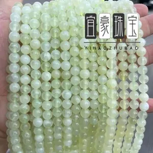 Macro shot of natural pale green gemstone beads in smooth round shapes for DIY jewelry