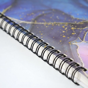 Thick A5 spiral notebook with blue purple nebula cover and black metal wire binding