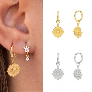 Evil eye coin hoop earrings in gold and silver finish with sparkling zircon accents