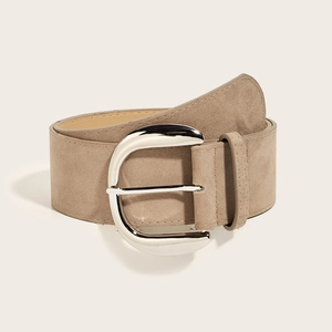 Close-up of a wide taupe suede belt featuring a large polished silver D-ring buckle