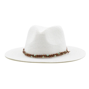 Detail of white straw fedora hat with green and brown beaded trim for beach sun protection