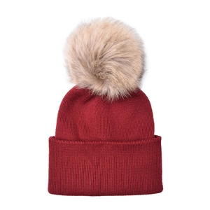 Close-up of burgundy knitted baby hat with a large fluffy beige faux fur pompom