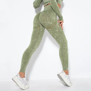 Detail of acid wash seamless yoga pants with peach lift effect in olive green