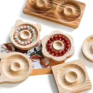 Macro view of assorted natural wood jewelry trays in flower, bear, and round shapes