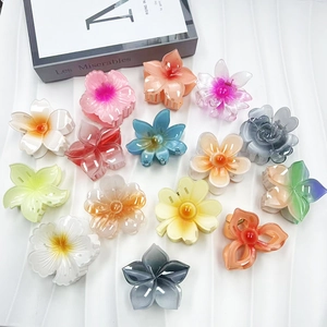 Gradient floral hair claws in various flower shapes and colors for summer styling