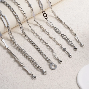 Silver stainless steel chain necklaces featuring Figaro, Cuban, and geometric links