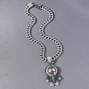 Macro detail of iced-out cartoon character pendant on silver Cuban link chain