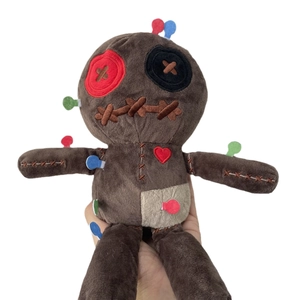 Brown plush voodoo doll with button eyes and red heart detail on white background
