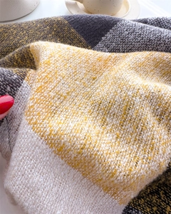 Close-up of soft brushed texture on plaid scarf with yellow, grey and white blocks