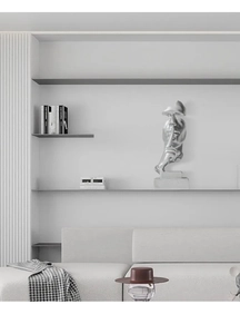 Detailed macro view of the silver Silence is Gold abstract face sculpture on a modern shelf