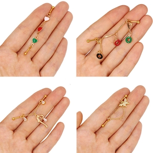 Detail showing various colorful charms and industrial bar bell studs on a hand