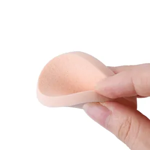 Soft nude makeup sponge for foundation showing high elasticity under finger pressure