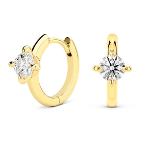 Detail of gold-plated geometric hoop earrings featuring brilliant-cut cubic zirconia