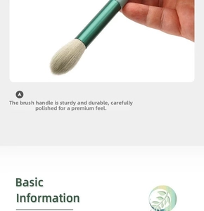 Detail of a large powder brush with dense white bristles and a dark green metallic handle