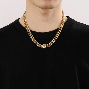 Close-up of 11mm gold-plated Cuban chain necklace with a diamond-encrusted round clasp