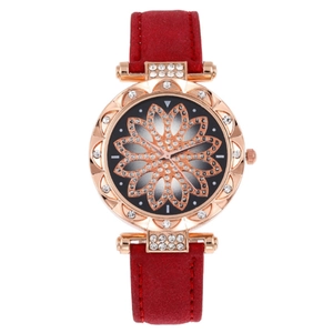 Detail of red suede watch strap with rose gold dial and floral rhinestone patterns